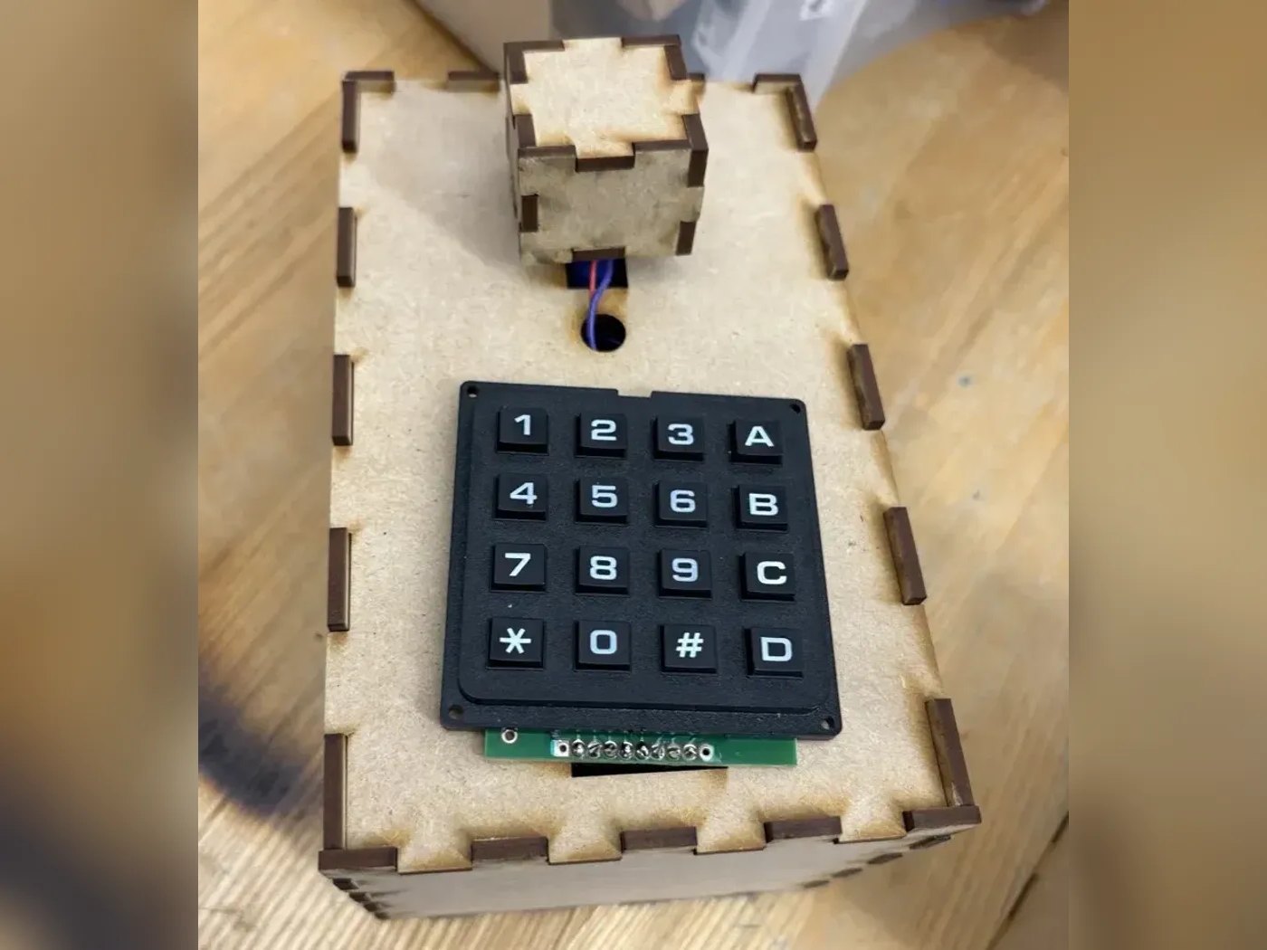 Top view of the transmitter showing the 16-key keypad and the laser housing on its servo