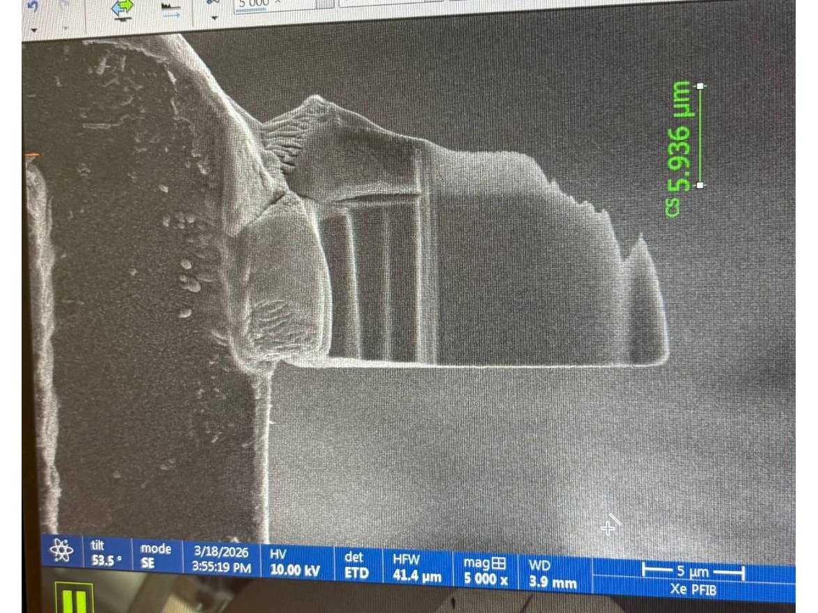 Close-up scanning electron image of a specimen with a 5.936 micrometer measurement marked in green, at 5,000 times magnification